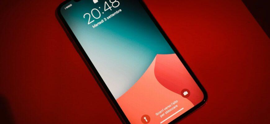 a close up of a cell phone on a red surface