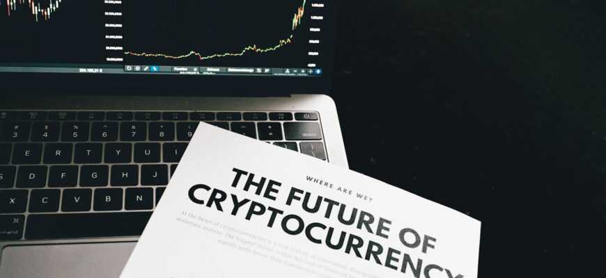 A detailed look at cryptocurrency market trends using a laptop and analytical document.